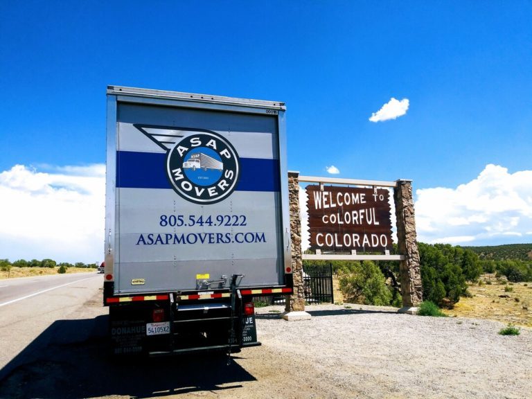ASAP Movers truck parked beside a Welcome to Colorful Colorado sign during a long-distance move