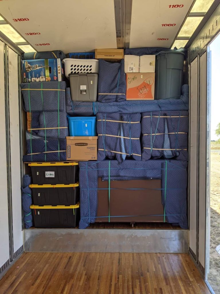 ASAP Movers truck packed from floor to ceiling with padded furniture and labeled bins