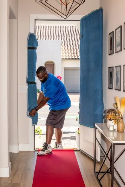 ASAP Movers team member moving furniture from a home
